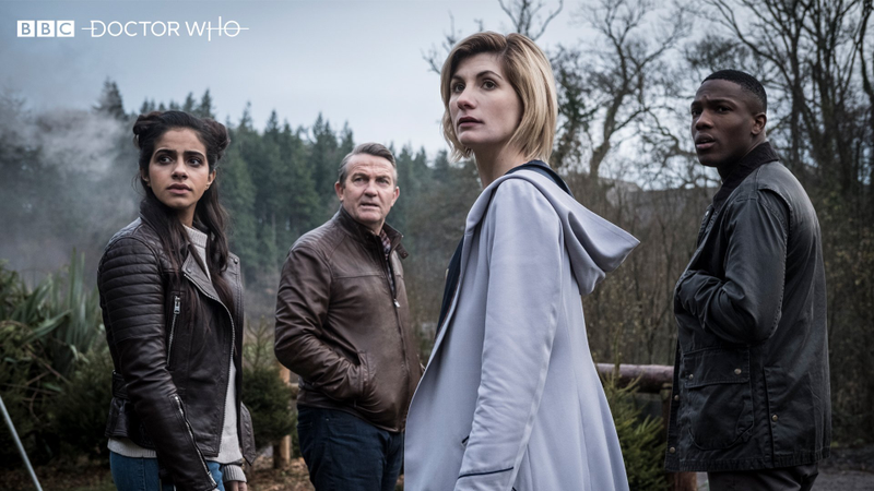 The Doctor and her new friends Yasmin, Graham, and Ryan. All wearing very nice coats.